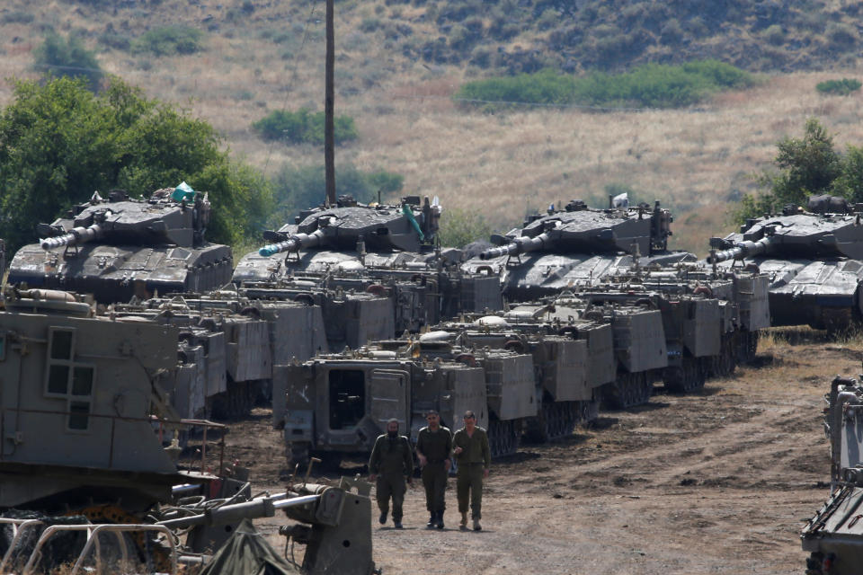 <p>Israeli soldiers walk among armored vehicles in the Israeli-occupied Golan Heights, Israel, May 10, 2018. (Photo: Ronen Zvulun/Reuters) </p>