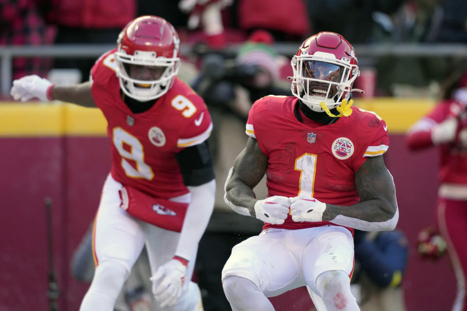 Kansas City Chiefs running back Jerick McKinnon (1) celebrates after scoring as teammates JuJu Smith-Schuster (9) watches during the first half of an NFL football game against the Seattle Seahawks Saturday, Dec. 24, 2022, in Kansas City, Mo. (AP Photo/Charlie Riedel)