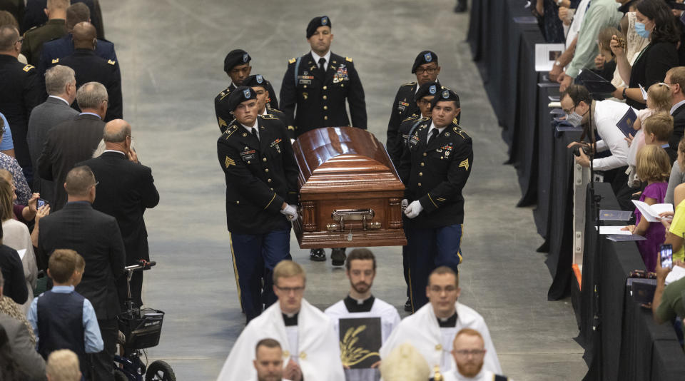 A Fort Riley honor guard carries the remains of Father Emil to an alter during Kapaun's funeral mass on Wednesday, Sept., 29, 2021 in Wichita, Kan. Kapaun died in a North Korean POW camp in May of 1951. He was posthumously awarded the Medal of Honor in 2013 for his bravery in the Korean War. Kapaun's remains were identified earlier this year returned home to Kansas recently. (Travis Heying/The Wichita Eagle via AP)