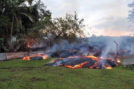 The lava flow from the Kilauea Volcano burns vegetation as it approaches a property boundary in a U.S. Geological Survey (USGS) image taken near the village of Pahoa, Hawaii, October 28, 2014. REUTERS/U.S. Geological Survey/Handout