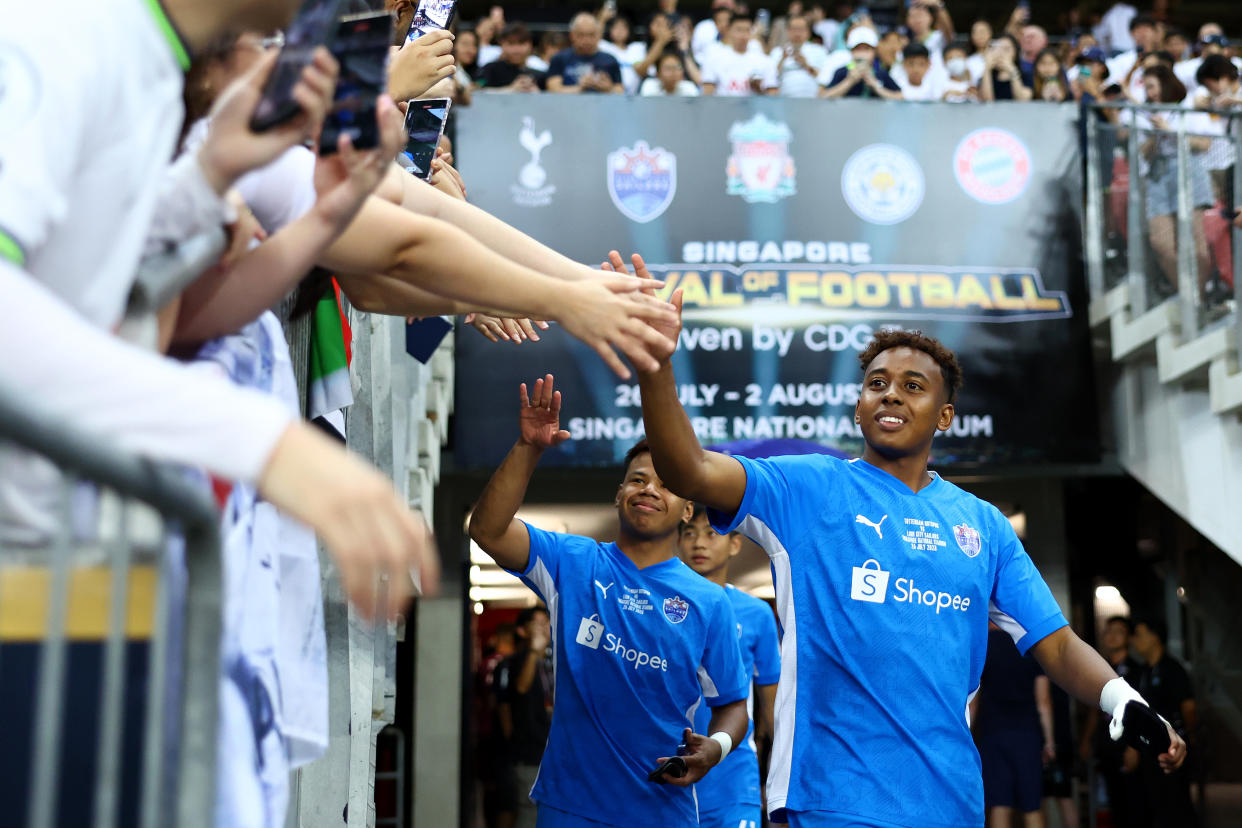 Lion City Sailors forward Abdul Rasaq greets fans as he walks out of the tunnel for warmups prior to the Singapore Festival of Football friendly against Tottenham Hotspur.