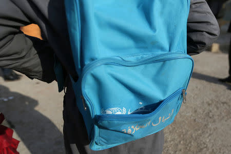 A student carries a Unicef-donated school bag in 'Aisha Mother of the BelieversÕ school which was recently reopened after rebels took control of al-Rai town from Islamic State militants, Syria January 17, 2017. Islamic State militants covered the UNICEF logo featured on the bags with the slogan "Cubs of the Caliphate" when they were in control of al-Rai town. Picture taken January 17, 2017. REUTERS/Khalil Ashawi