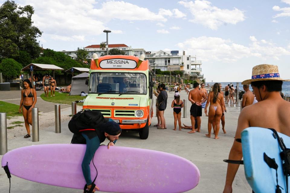 People line up outside an ice cream truck as parts of Australia’s east reached their hottest day in more than two years (Reuters)