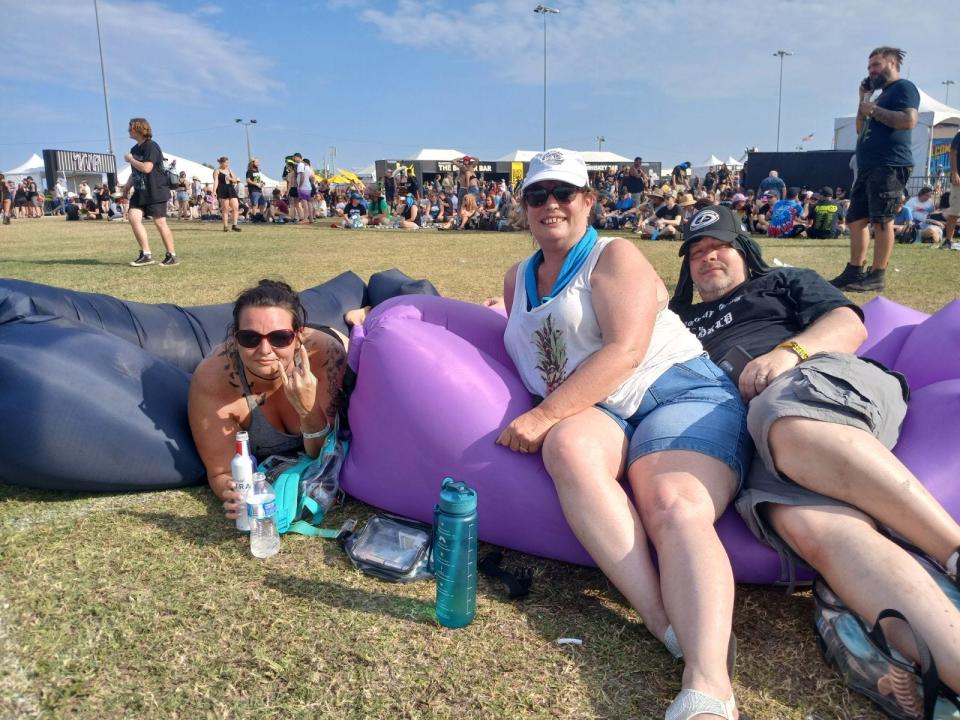 From left, Jennifer Gradias, Laura and Seth Hassan enjoy a rest on some inflatable couches while taking in Welcome to Rockville on Day 2 at Daytona International Speedway.