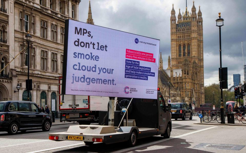 An advertising van urges MPs to vote for a ban on smoking as it is driven past Parliament