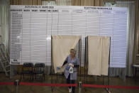 A worker disinfects a voting booth to protect from the new coronavirus at a voting center in the French-Italian border city of Menton, southern France, Sunday, March 15, 2020. For most people, the new coronavirus causes only mild or moderate symptoms. For some it can cause more severe illness. France pressed ahead with plans for nationwide municipal elections on Sunday but ordered special measures to keep people at a safe distance and to sanitize surfaces. (AP Photo/Daniel Cole)