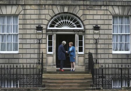 Scotland's First Minister, Nicola Sturgeon (R), greets Britain's new Prime Minister, Theresa May, as she arrives at Bute House in Edinburgh, Scotland, Britain July 15, 2016. REUTERS/Russell Cheyne