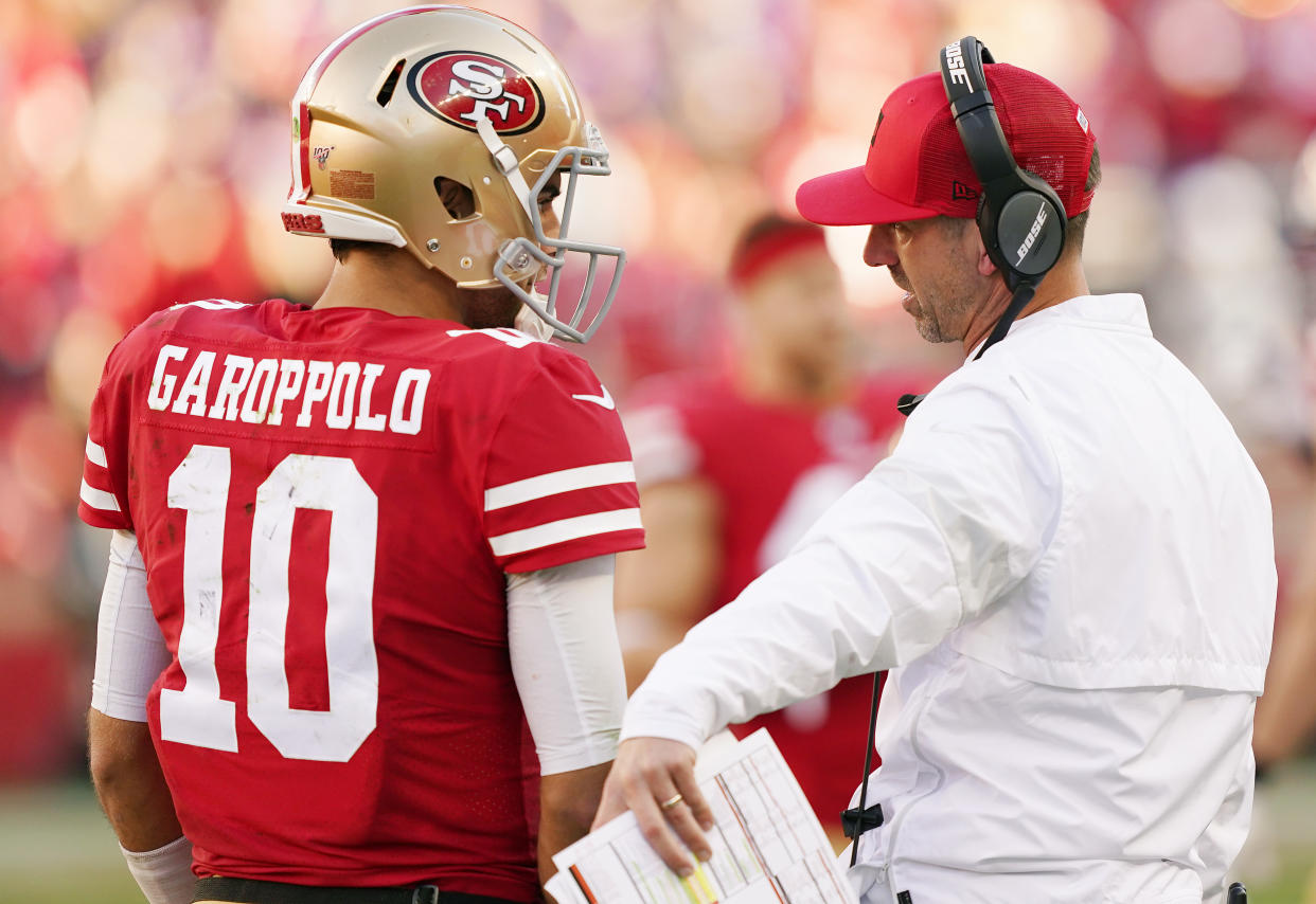 SANTA CLARA, CALIFORNIA - JANUARY 11: Jimmy Garoppolo #10 speaks with head coach Kyle Shanahan of the San Francisco 49ers during the NFC Divisional Round Playoff game against the Minnesota Vikings at Levi's Stadium on January 11, 2020 in Santa Clara, California. (Photo by Thearon W. Henderson/Getty Images)