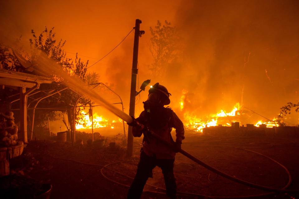 A firefighter works against the Lake Hughes fire in Angeles National Forest on Wednesday, Aug. 12, 2020, north of Santa Clarita, Calif. (AP Photo/Ringo H.W. Chiu)