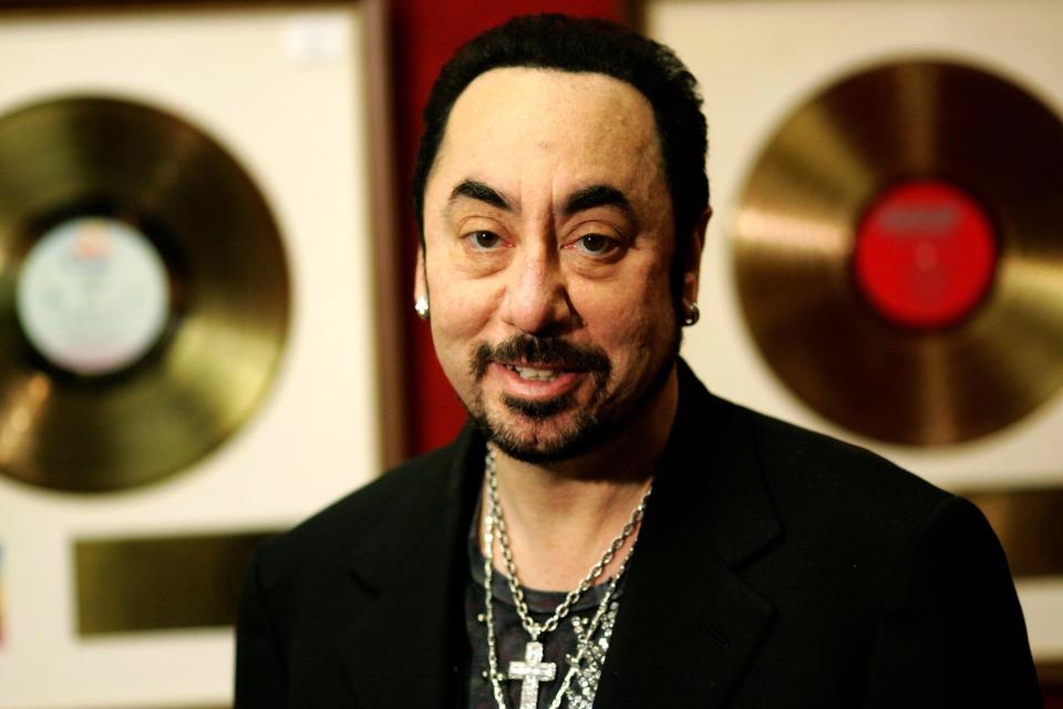 U.S. music producer David Gest poses with some of his collection of entertainment memorabilia at an auction house in London, Wednesday, Nov. 21, 2007. The collection includes more than 120 presentation Gold singles and albums, amongst them are The Beatles songs Yellow Submarine, Help! and Penny Lane as well as the Rolling Stones' I Can't Get No Satisfaction and The Doors' Light My Fire. The latter were previously Jim Morrison's personal copies. The collection is to be auctioned on Dec. 5 in London. (AP Photo/Sang Tan)