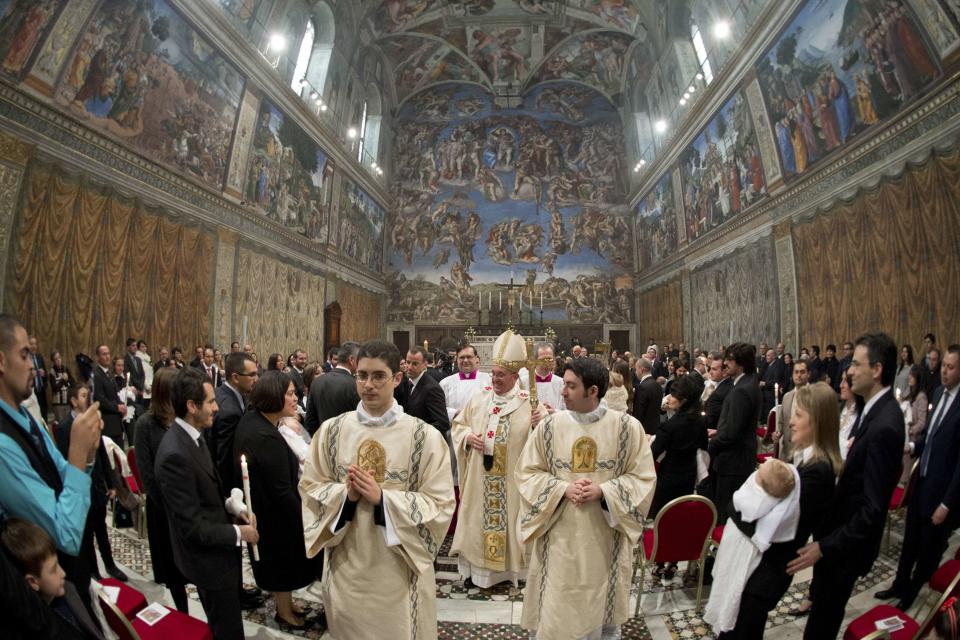 Pope Francis leaves at the end of a mass where 32 babies were baptized in the Sistine Chapel at the Vatican