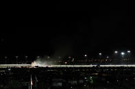 DAYTONA BEACH, FL - FEBRUARY 27: Safety workers try to extinguish a fire from a jet dryer after being hit by Juan Pablo Montoya, driver of the #42 Target Chevrolet, under caution during the NASCAR Sprint Cup Series Daytona 500 at Daytona International Speedway on February 27, 2012 in Daytona Beach, Florida. (Photo by Streeter Lecka/Getty Images)