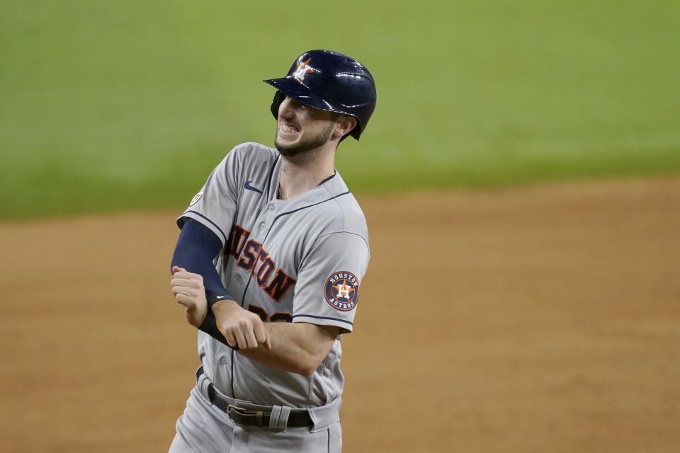 Houston Astros' Kyle Tucker gestures to the team's dugout as he rounds the bases after hitting a solo home run in the eighth inning of a baseball game against the Texas Rangers in Arlington, Texas, Wednesday, Sept. 15, 2021. (AP Photo/Tony Gutierrez)