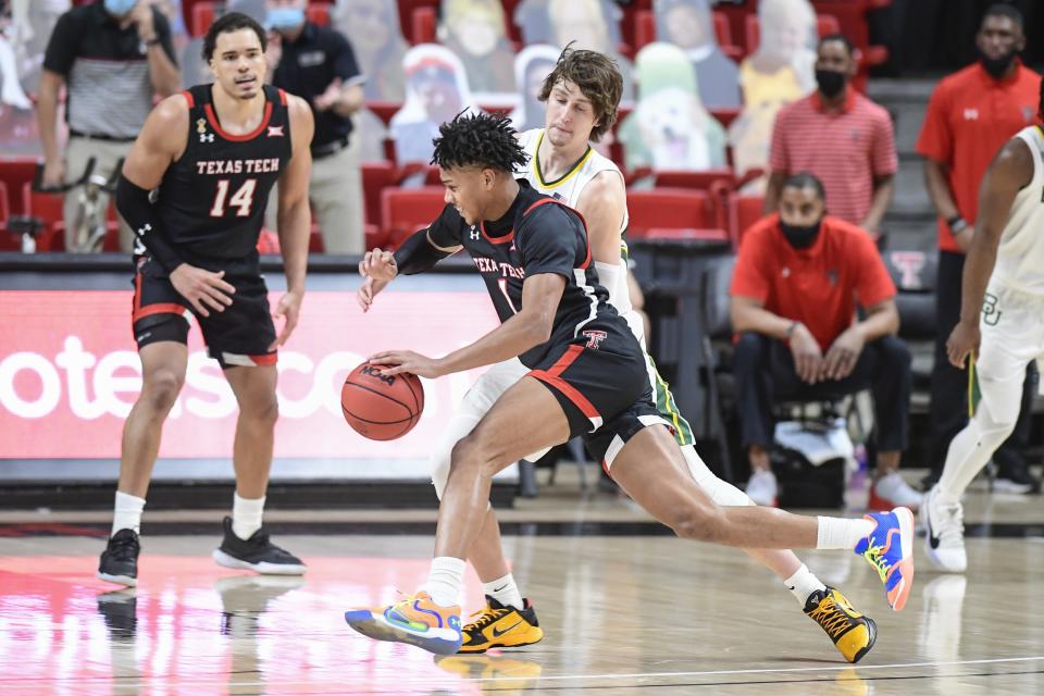 Texas Tech's Terrence Shannon Jr. (1) dribbles the ball against Baylor's Matthew Mayer (24) during the second half of an NCAA college basketball game in Lubbock, Texas, Saturday, Jan. 16, 2021. (AP Photo/Justin Rex)