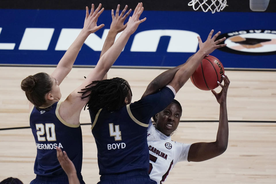 South Carolina forward Laeticia Amihere, right, shoots against Georgia Tech center Nerea Hermosa (20) and guard Anaya Boyd (4) during the first half of a college basketball game in the Sweet Sixteen round of the women's NCAA tournament at the Alamodome in San Antonio, Sunday, March 28, 2021. (AP Photo/Eric Gay)