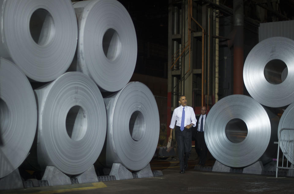 President Barack Obama walks past coils of steel as he arrives to speak on the economy at the ArcelorMittal Cleveland steel mill in Cleveland, Ohio, on November 14, 2013.