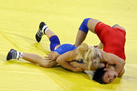 BEIJING - AUGUST 16: Li Xiaomei of China (red) competes against Irini Merleni of Ukraine in the women's 48kg freestyle wrestling event held at the China Agriculture University Gymnasium on Day 8 of the Beijing 2008 Olympic Games on August 16, 2008 in Beijing, China. (Photo by Jeff Gross/Getty Images)