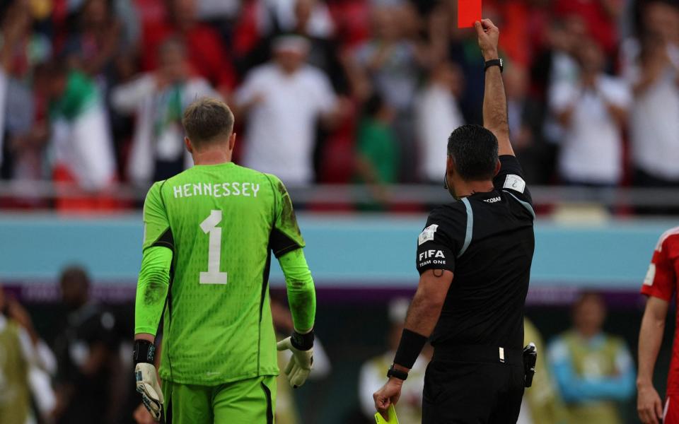 Mario Escobar shows a red card to Wales' goalkeeper #01 Wayne Hennessey following a VR review during the Qatar 2022 World Cup Group B football match between Wales and Iran at the Ahmad Bin Ali Stadium - AFP