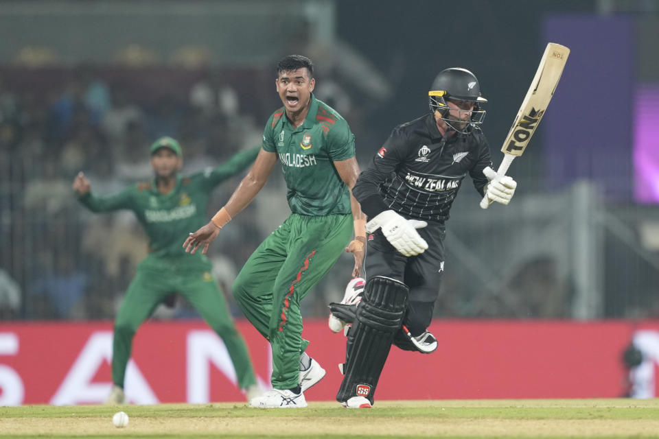 New Zealand's Devon Conway, right, run between the wickets during the ICC Men's Cricket World Cup match between New Zealand and Bangladesh in Chennai , India, Friday, Oct. 13, 2023. (AP Photo/Eranga Jayawardena)