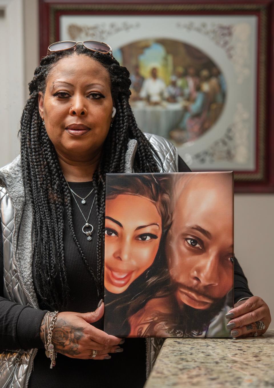 Diyawn Caldwell, founder and president of Both Sides of the Wall, and organizer of the Alabama Prison Strike, with a picture of her and her husband Cordarius Caldwell at her home in Pensacola Florida Sunday, January 8, 2023. Her husband is in an Alabama prison.
