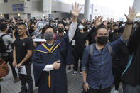 Protesters hold up their hands to represent their five demands during a makeshift memorial for Chow Tsz-Lok at the University of Science and Technology in Hong Kong on Friday, Nov. 8, 2019. Chow, a student from the University who fell off a parking garage after police fired tear gas during clashes with anti-government protesters died Friday, in a rare fatality after five months of unrest that intensified anger in the semi-autonomous Chinese territory. (AP Photo/Kin Cheung)