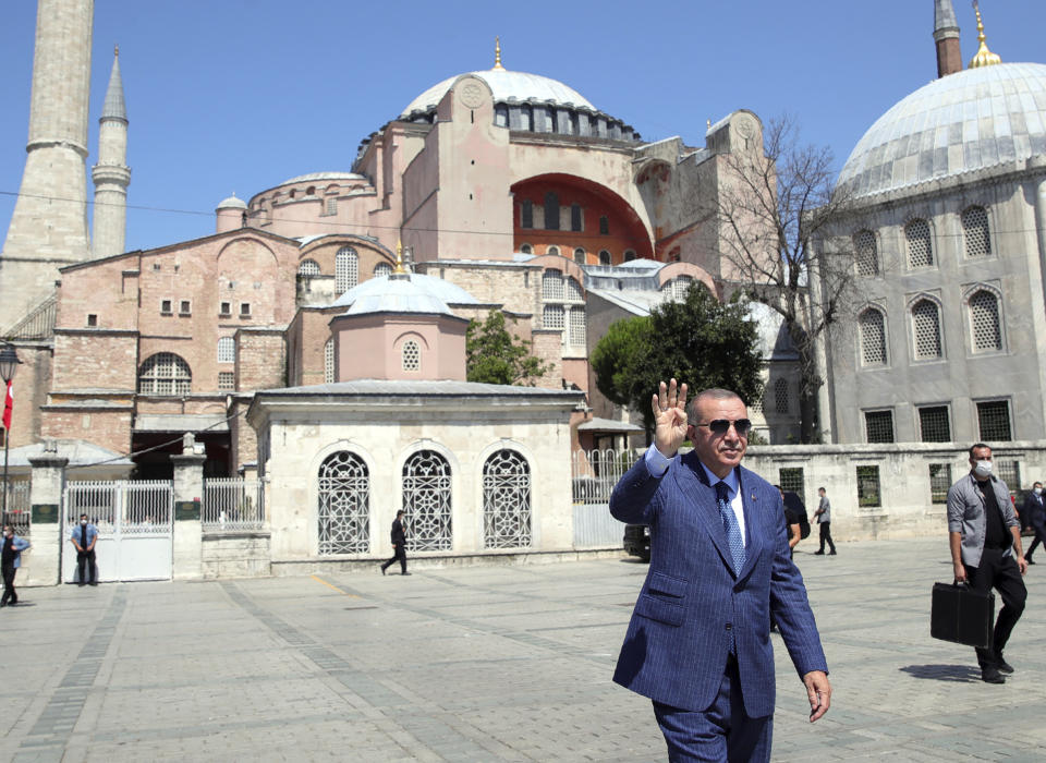 Turkey's President Recep Tayyip Erdogan gestures as he arrives to speak to supporters and the media after Friday prayers in Hagia Sophia, in the background, in Istanbul, Friday, Aug. 7, 2020. Erdogan joined worshipers on July 24 for the first Muslim prayers in 86 years inside the Istanbul landmark that served as one of Christendom's most significant cathedrals, a mosque and a museum before its conversion back into a Muslim place of worship.Turkey's president has called a maritime deal between Greece and Egypt "worthless," saying Turkey will resume oil and gas exploration in the Eastern Mediterranean.(Turkish Presidency via AP, Pool)