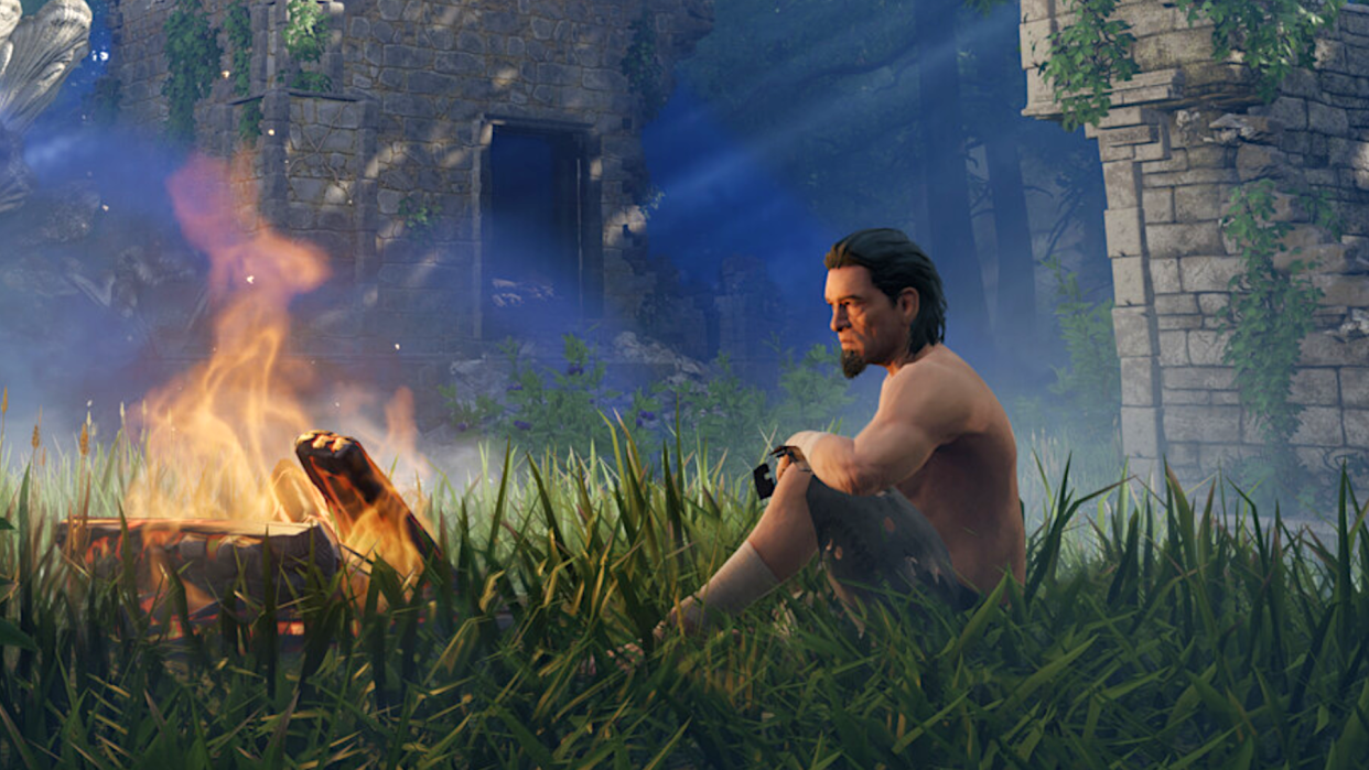  An adventurer in Keen Games' enshrouded sits by a crackling campfire in the middle of a forest clearing. 