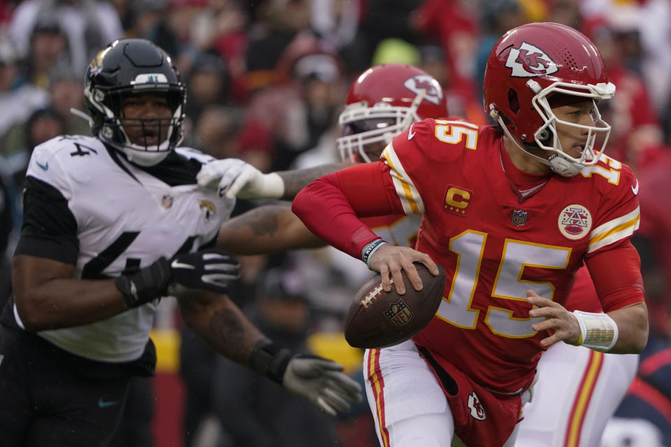 Kansas City Chiefs quarterback Patrick Mahomes (15) runs out of the pocket against the Jacksonville Jaguars during the first half of an NFL divisional round playoff football game, Saturday, Jan. 21, 2023, in Kansas City, Mo. (AP Photo/Ed Zurga)