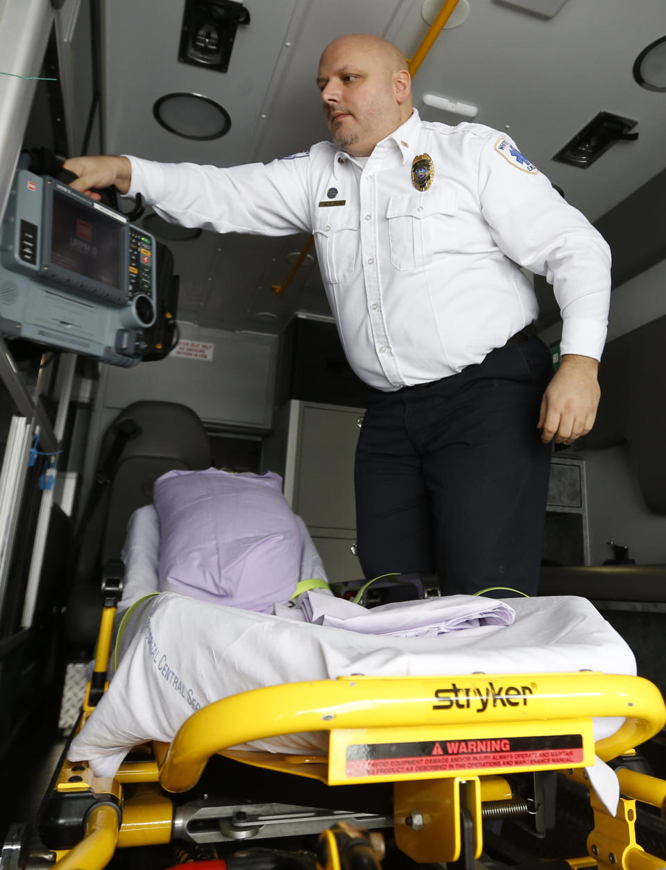 Paul Falavolito, the chief of a small, non-profit ambulance service looks over equipment in one of the ambulances at the base in White Oak, Pa. on Monday, Feb. 10, 2014. Changes in weather are important for Falavolito's ambulance service, and he was thus outraged last month when he flipped on DirecTV's replacement weather service, WeatherNation TV, and it was broadcasting a seven-day extended forecast for Los Angeles while he was in the Northeast. (AP Photo/Keith Srakocic)