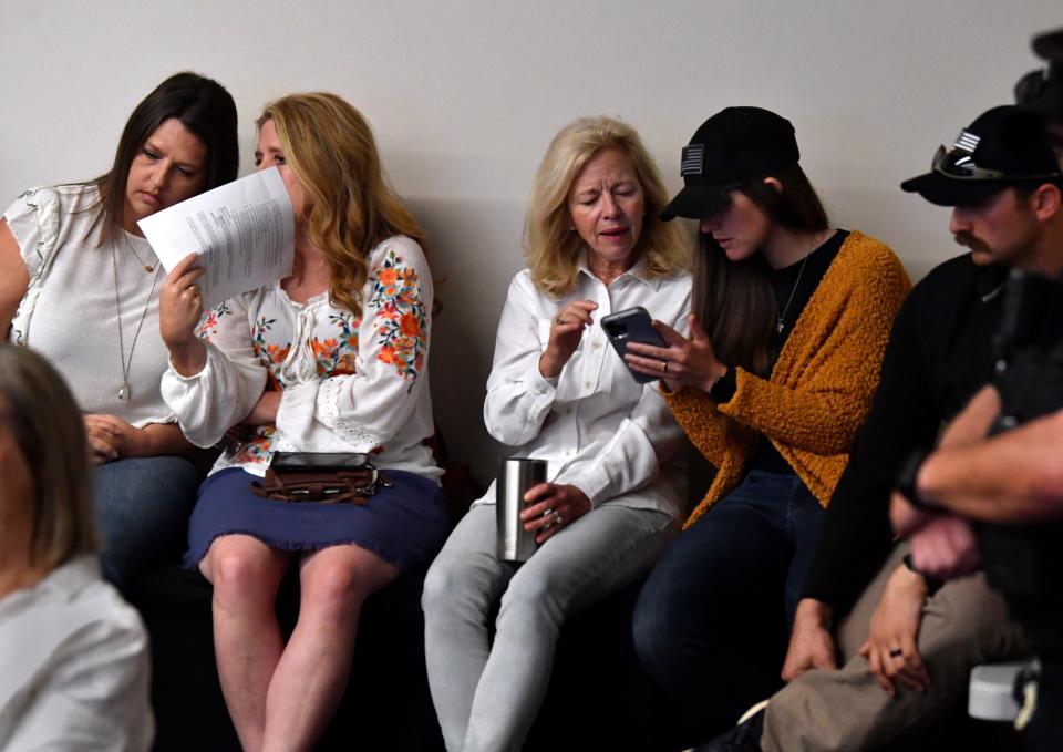 Tai Ann McClendon and Shelli Presley (left) talk as Laurie Eagle looks at something on Lauren Ramelot's phone during Abilene City Council meeting April 28. The group was one of many who came out in support of a proposed ordinance making Abilene a "sanctuary city for the unborn".