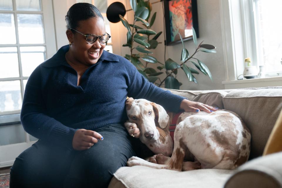 Astro cuddles up next to Tatiana Darby Tuesday in her Kansas City, Missouri, apartment while she talks about why she likes him.