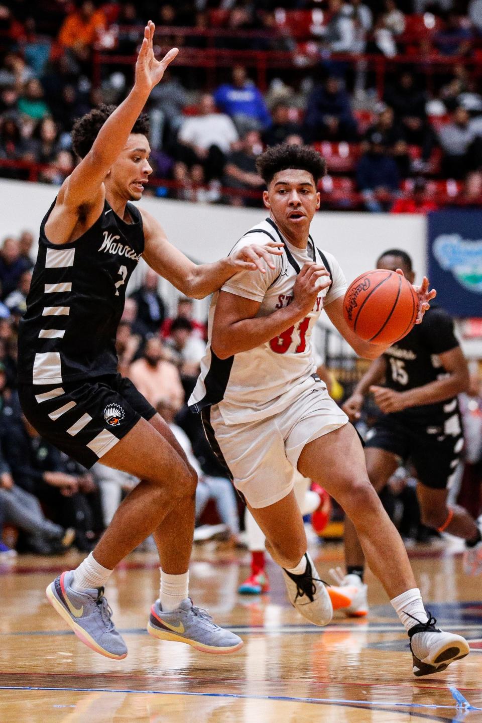 Orchard Lake St. Mary's forward Jayden Savoury dribbles against Birmingham Brother Rice forward Elijah Williams during the second half of MHSAA Division 1 quarterfinal at Calihan Hall in Detroit on Tuesday, March 12, 2024.