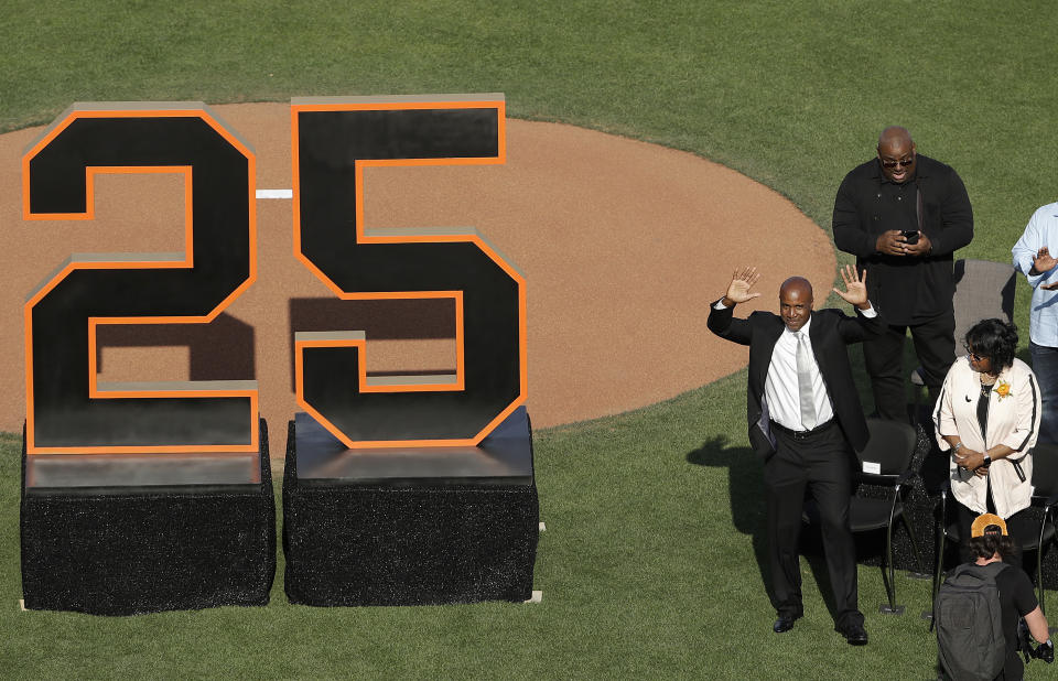 Former San Francisco Giants player Barry Bonds waves to fans next to his mother, Pat, as he is honored during a ceremony to retire his jersey number before a baseball game between the Giants and the Pittsburgh Pirates in San Francisco, Saturday, Aug. 11, 2018. (AP Photo/Jeff Chiu, Pool)