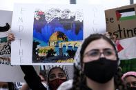 A demonstrator holding a sign takes part in a protest outside the Federal Building against Israel and in support of Palestinians, Saturday, May 15, 2021 in the Westwood section of Los Angeles. (AP Photo/Ringo H.W. Chiu)