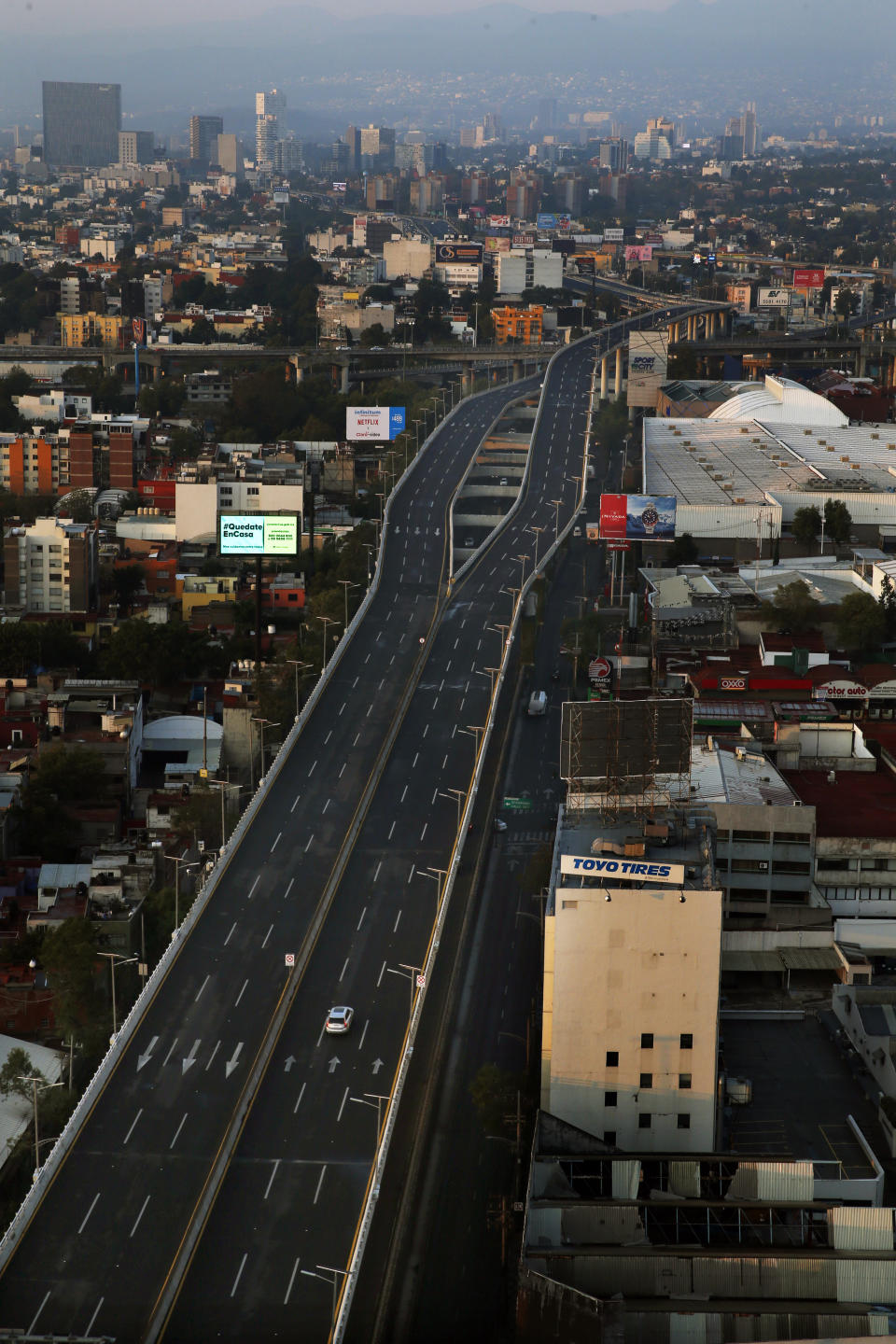The Adlfo Lopez Mateo Boulevard, better known as "El Periferico," or The Periphery, is nearly devoid of traffic in Mexico City, early Friday, May 8, 2020. The previous day, Mexico saw its largest one-day increase yet in confirmed cases of COVID-19. (AP Photo/Marco Ugarte)