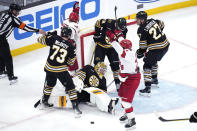 Boston Bruins goaltender Jeremy Swayman (1) sits on the ice as Carolina Hurricanes center Jake Guentzel (59) celebrates after scoring during the third period of an NHL hockey game, Tuesday, April 9, 2024, in Boston. (AP Photo/Charles Krupa)