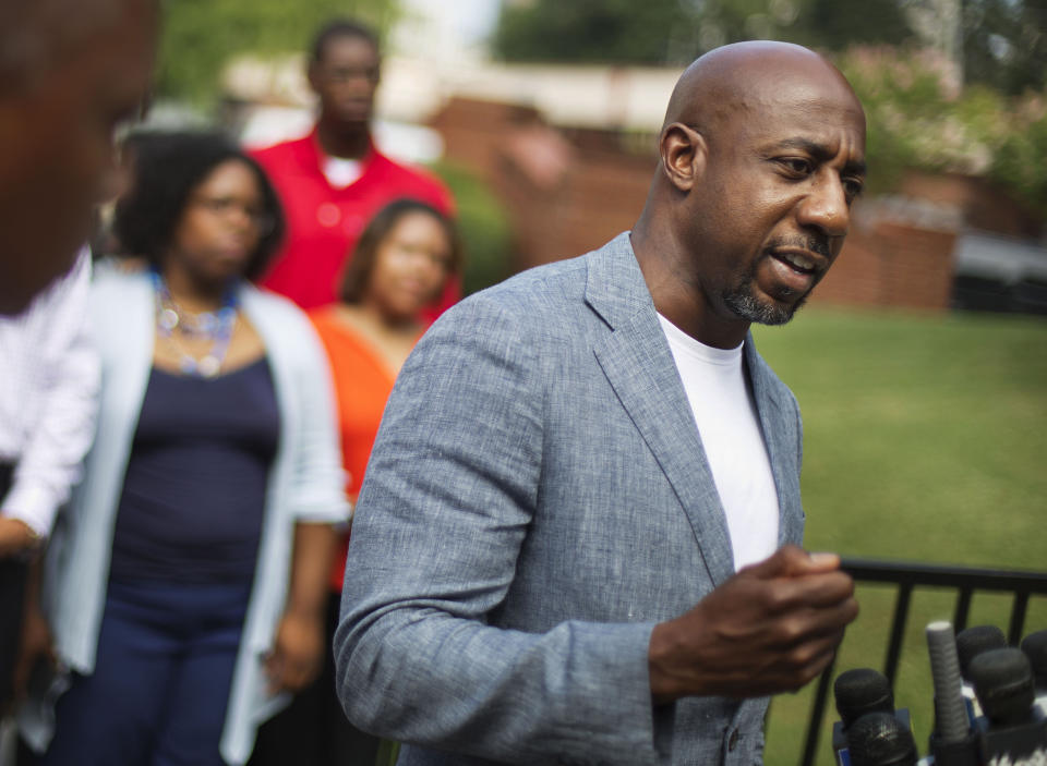 FILE - In this July 30, 2015 file photo, Rev. Raphael G. Warnock, pastor of Ebenezer Baptist Church, right, speaks during a press conference after Confederate flags were found on the church's premises in Atlanta. Warnock announced his campaign for the U.S. Senate on Thursday, Jan. 30, 2020 challenging recently appointed Republican Kelly Loeffler. (AP Photo/David Goldman, File)