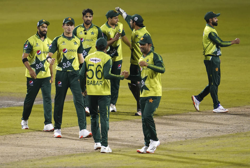 FILE - In this Tuesday Sept. 1, 2020, file photo, Pakistan players celebrate their win in the third Twenty20 cricket match against England at Old Trafford in Manchester, England. Six members of the Pakistan cricket squad in New Zealand have tested positive, Thursday Nov. 26, 2020 for COVID-19 and have been moved from managed isolation into quarantine. (AP Photo/Jon Super, Pool, File)