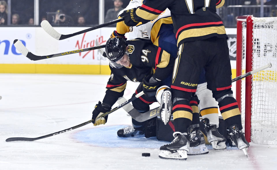 Vegas Golden Knights defenseman Brayden Pachal (94) defends the goal against the Nashville Predators during the first period of an NHL hockey game Saturday, Dec. 31, 2022, in Las Vegas. (AP Photo/David Becker)