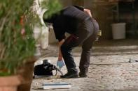 A police officer in protective gear inspects a backpack used to carry an explosive device at the scene of the attack in Ansbach, southern Germany on July 25, 2016