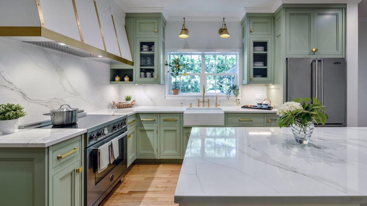 a kitchen with green cabinets