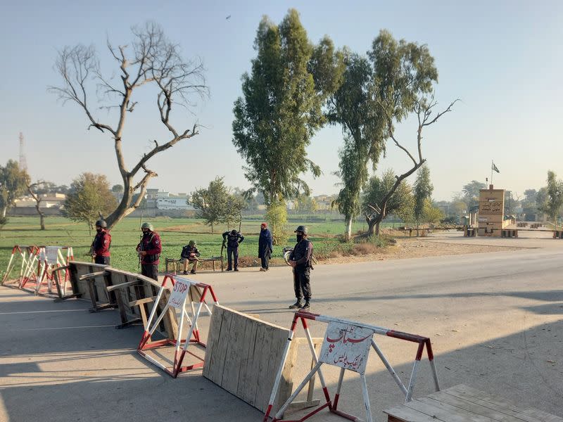 Pakistani soldiers stand guard on a road leading to the cantonment area in Bannu