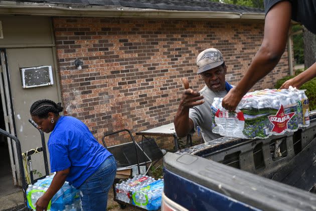 Rodney Moore (center), maintenance supervisor at Addison Place apartments, receives cases of bottled water from City of Jackson worker Dianna Davis (right) and Andrea Williams for elderly and disabled residents on Sept. 3 in Jackson. (Photo: The Washington Post via Getty Images)