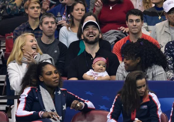 Serena’s husband Ohanian, seen holding Olympia during a Fed Cup match in February, has brought their daughter to most of her mother’s matches since she returned to tennis.