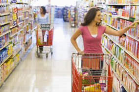 women grocery shopping in...