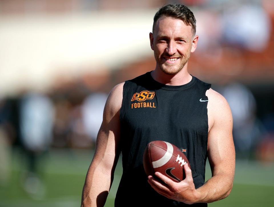 Oklahoma State's Tom Hutton (29) warms up before the college football game between Oklahoma State University Cowboys (OSU) and Kansas State University Wildcats at Boone Pickens Stadium in Stillwater, Okla., Saturday, Sept. 25, 2021.