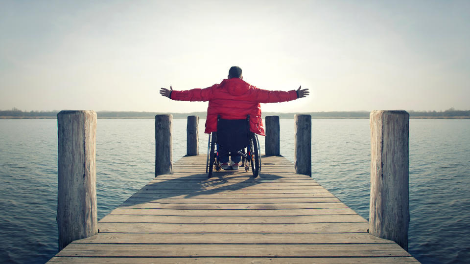 handicapped man traveling on lake dock