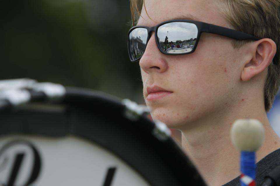 The Gahanna marching band is reflected in the sunglasses of sophomore Connor Smeck during band practice July 26.