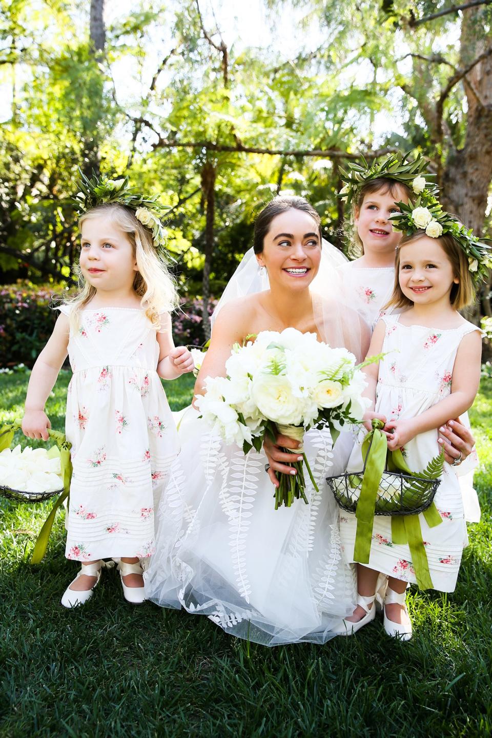 The bride wore Oscar de la Renta, inspired by her grandmother, for her greenery-filled ceremony at the Beverly Hills Hotel.