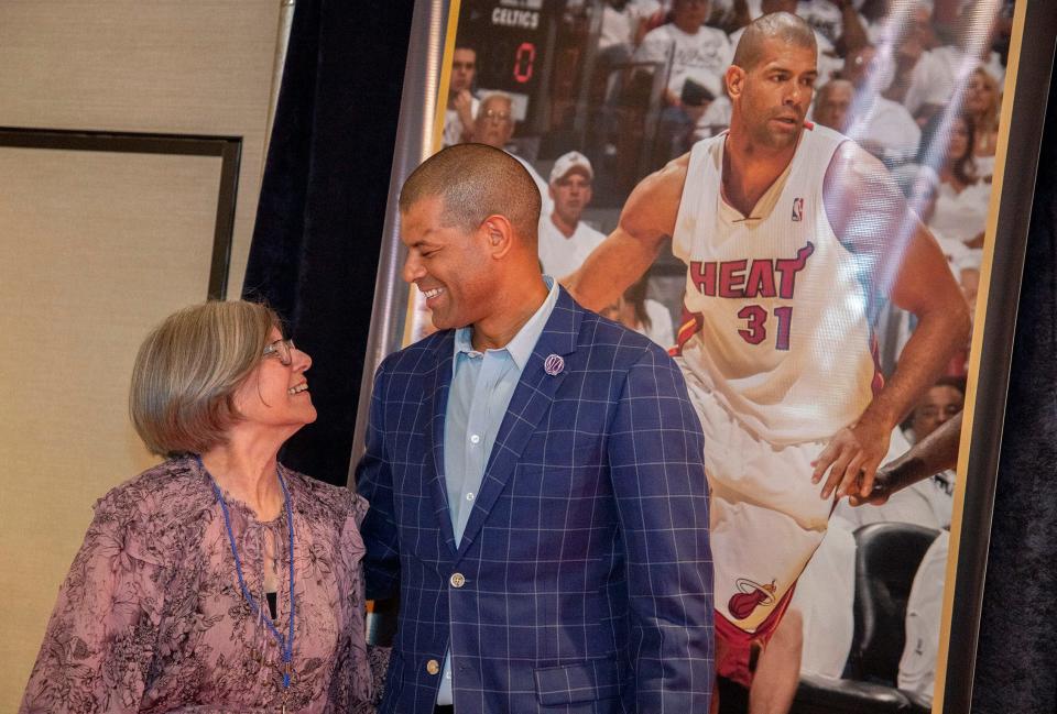 Sandeeps Battier, of Birmingham, left, looks up at her son Shane Battier and 2022 inductee into the Michigan Sports Hall of Fame, as they have their photo taken in front of his banner at the induction event at the MotorCity Hotel Casino SoundBoard in Detroit on September 10, 2022. Battier was a basketball star at Detroit Country Day School, and earned Michigan's "Mr. Basketball' award. He went on to Duke and won two NBA championships.